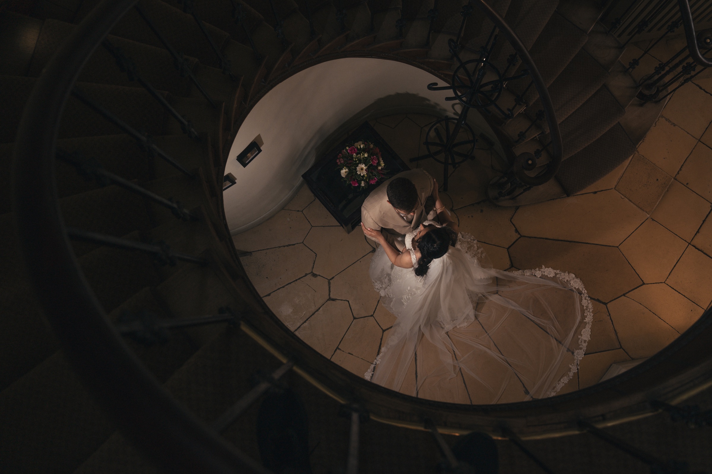 A newly married couple seen from above on a spiral staircase