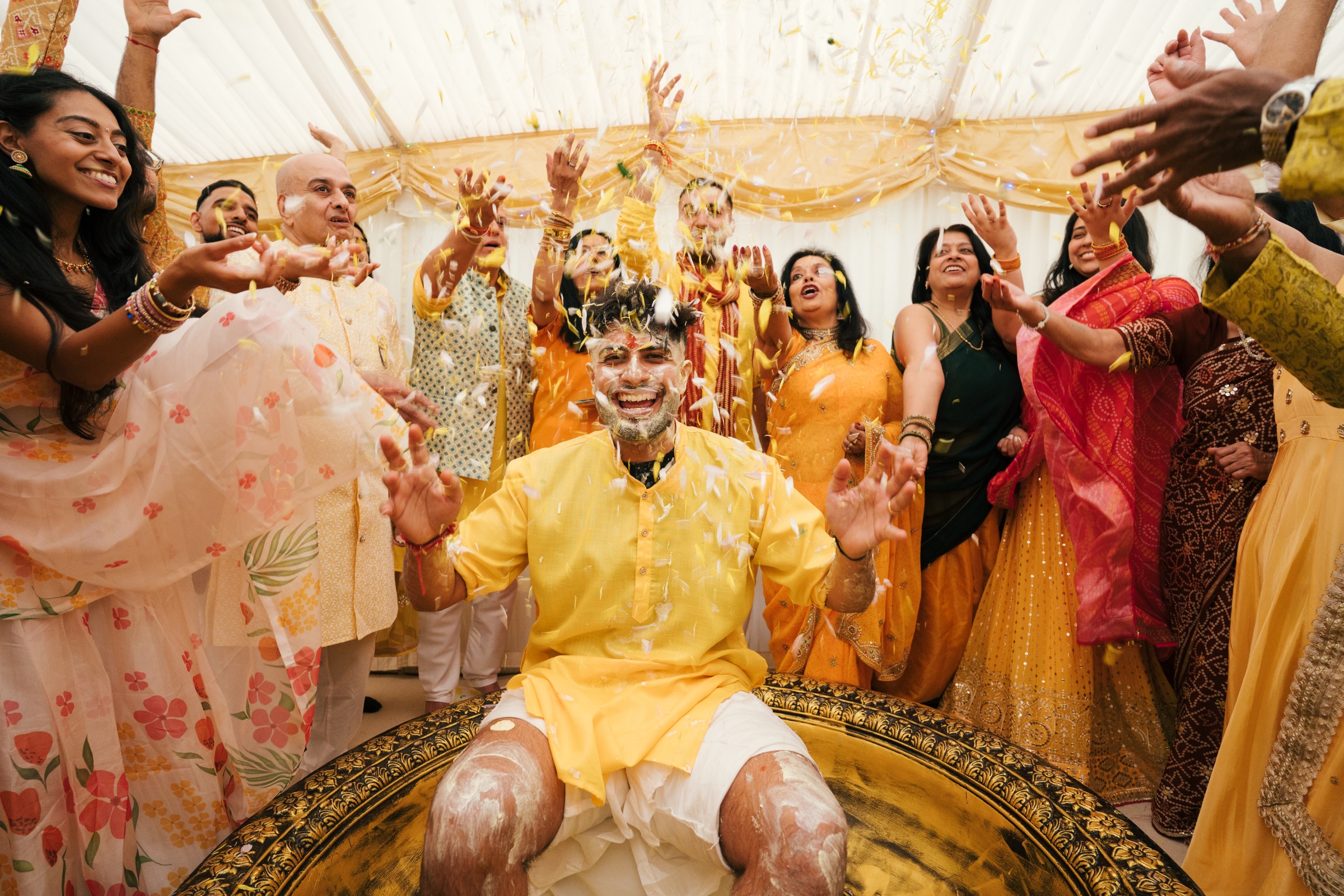 Family celebrating together during a haldi ceremony